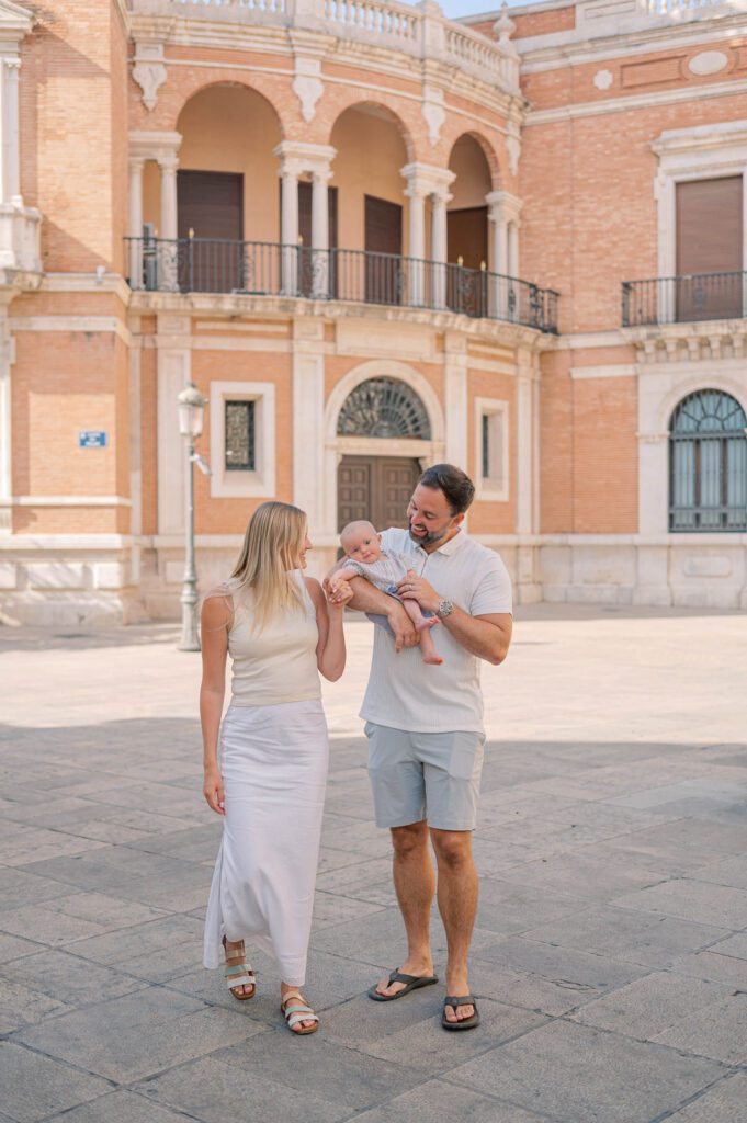 Family wearing pastel linen outfits during an Old Town photoshoot near Valencia Cathedral