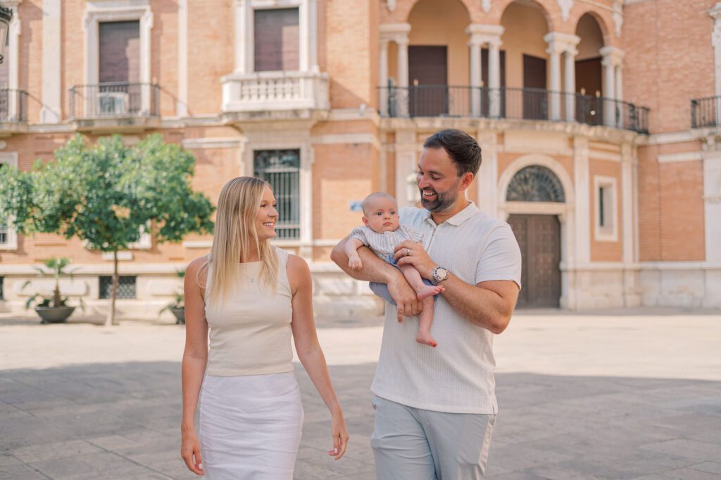 Young family with a baby during a relaxed photoshoot in the historical center of Valencia