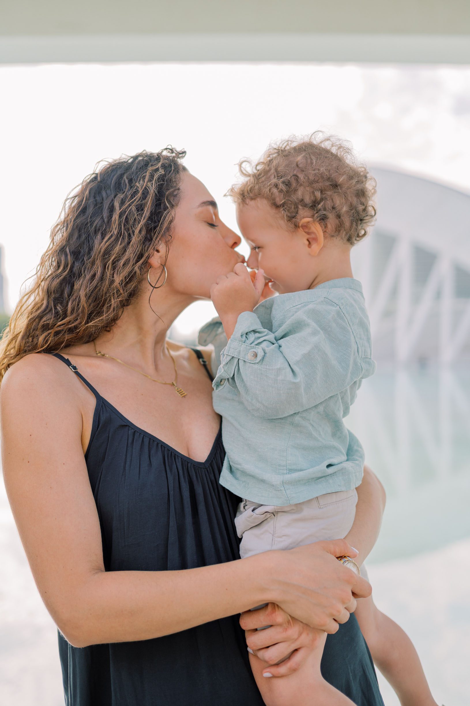 Mother and son having a tender moment during a relaxed family photoshoot at the City of Arts and Sciences in Valencia
