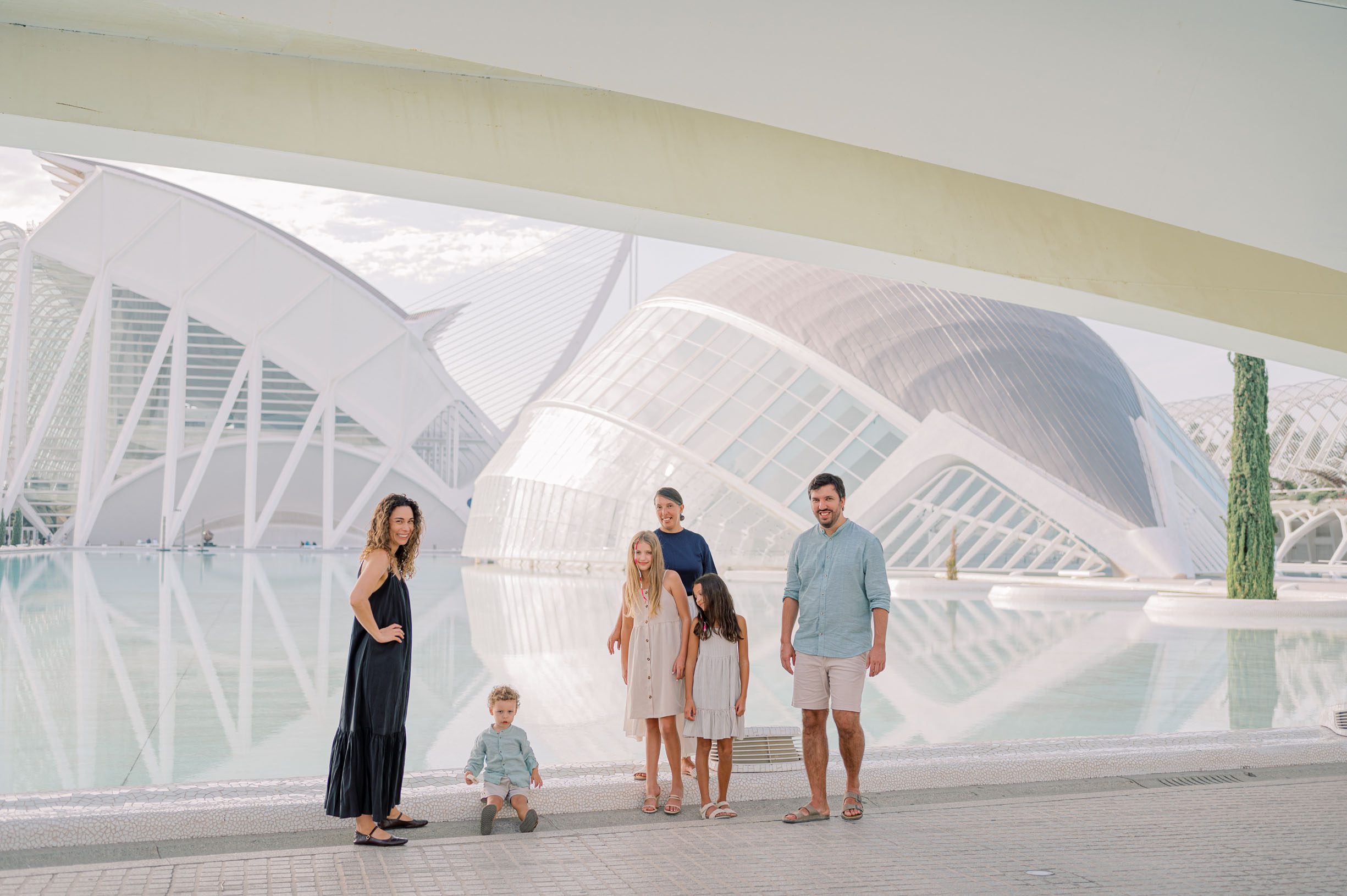 Family photographed beside the reflecting pools and modern architecture of the City of Arts and Sciences