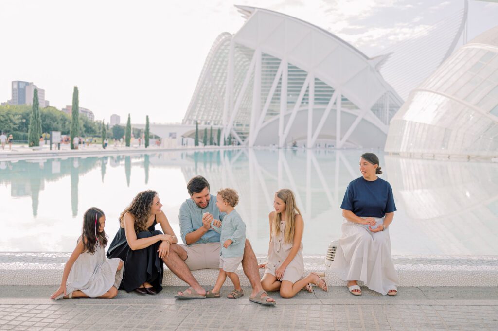 Family photographed beside the reflecting pools and modern architecture of the City of Arts and Sciences