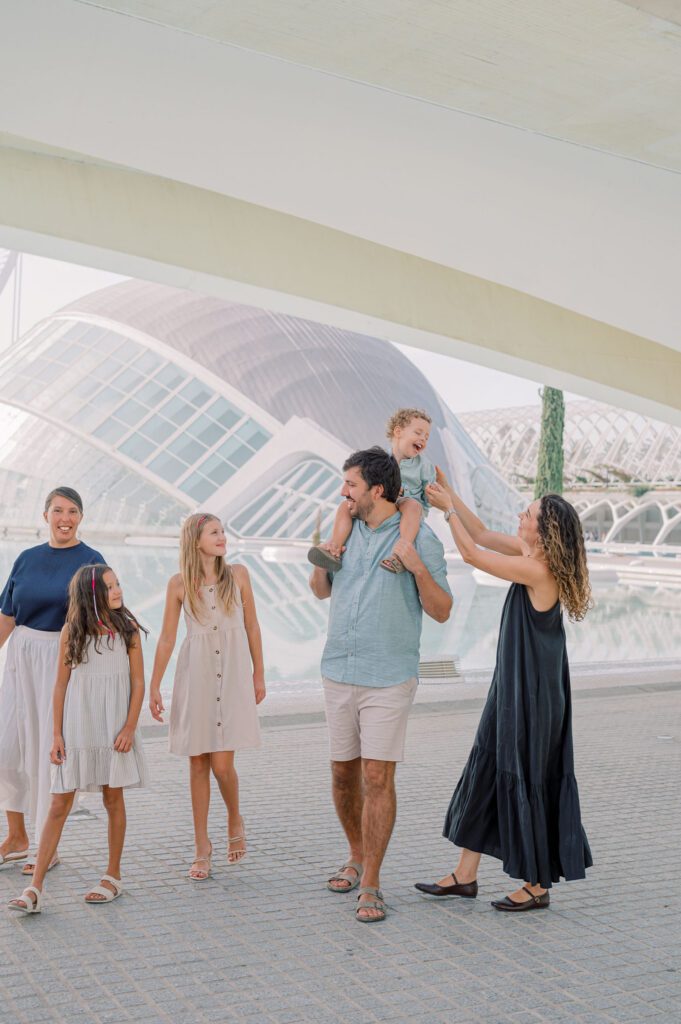 Family photographed beside the reflecting pools and modern architecture of the City of Arts and Sciences