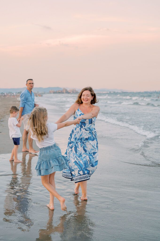 Family enjoying the sea during a sunset family photoshoot at Patacona Beach
