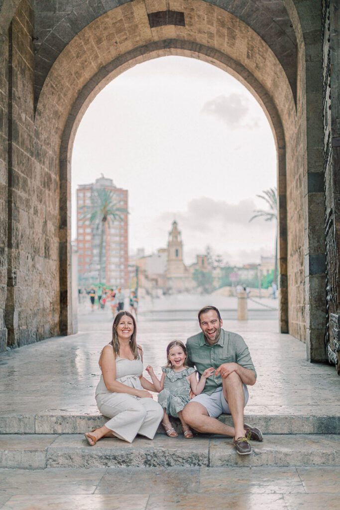 Parents with their young daughter and toddler near Torres de Serranos during a family photoshoot in Valencia