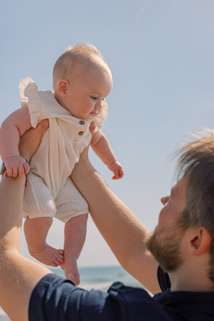 Father sharing an emotional moment with his baby during a family photoshoot at Patacona Beach